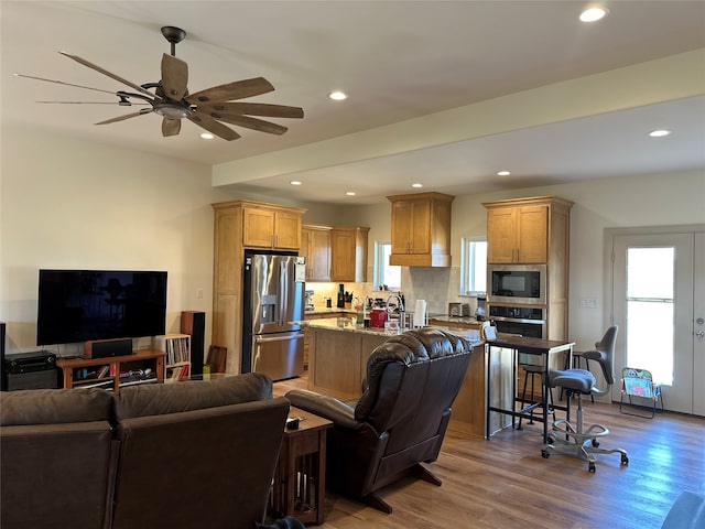 living room with recessed lighting, a healthy amount of sunlight, wood finished floors, and ceiling fan