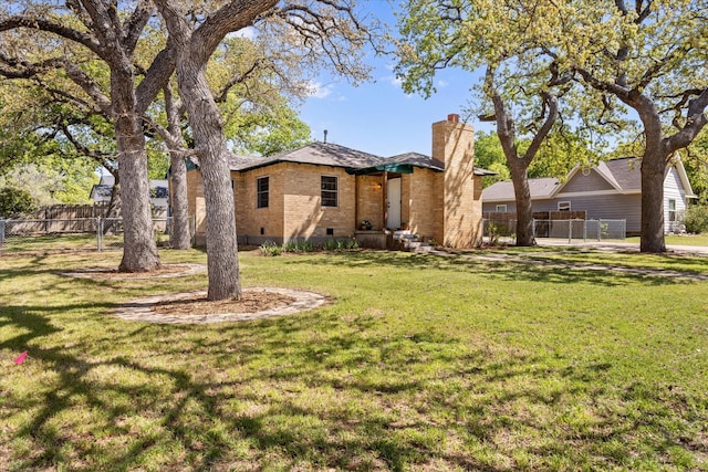 exterior space with crawl space, fence, a chimney, a front lawn, and brick siding