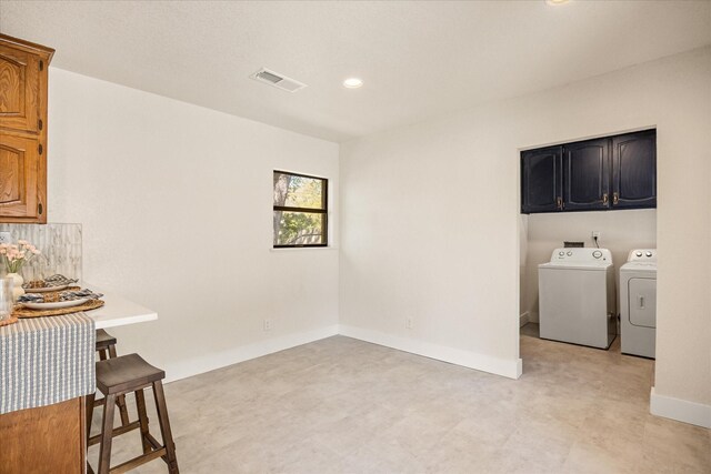 201 E 3rd St, Weatherford, TX 76086 - laundry area with cabinet space, separate washer and dryer, recessed lighting, and light flooring
