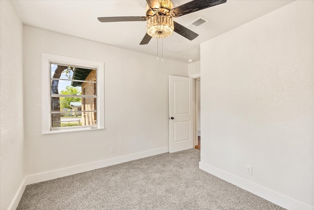 spare room featuring baseboards, light carpet, visible vents, and a ceiling fan