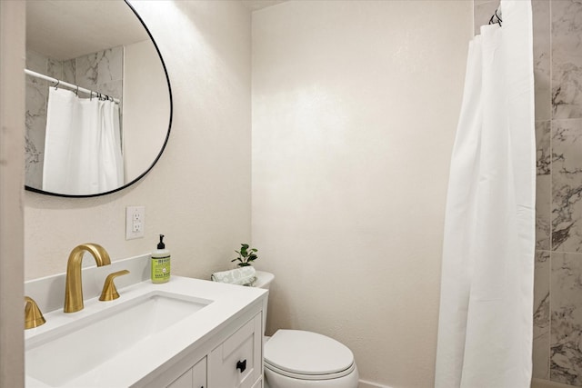 full bath with toilet, tiled shower, and vanity