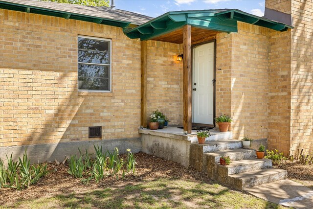 201 E 3rd St, Weatherford, TX 76086 - view of exterior entry with brick siding and crawl space