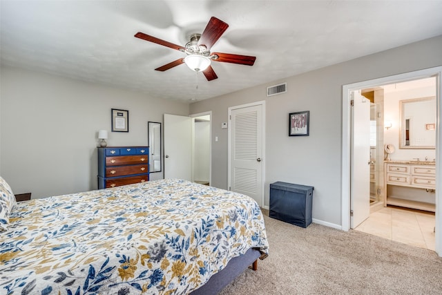 carpeted bedroom featuring baseboards, visible vents, ensuite bath, ceiling fan, and a closet