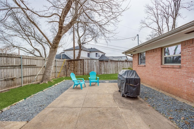 view of patio featuring a fenced backyard and a grill