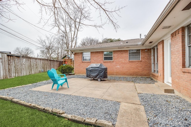 view of patio / terrace with grilling area and a fenced backyard