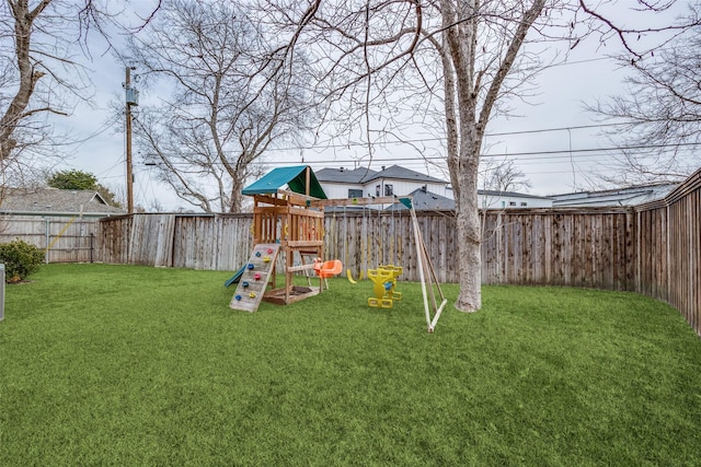 view of yard with a playground and a fenced backyard