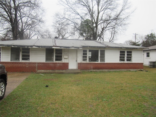 ranch-style home with brick siding, central AC, and a front lawn