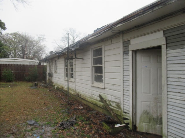 view of property exterior featuring fence