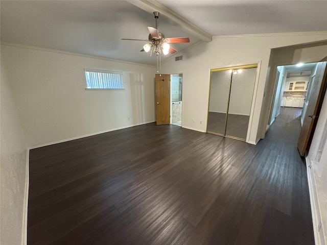 unfurnished bedroom with visible vents, baseboards, dark wood finished floors, lofted ceiling with beams, and a closet