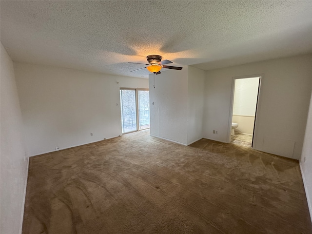 spare room with a textured ceiling, a ceiling fan, and light carpet