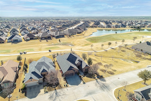 drone / aerial view featuring a residential view and a water view