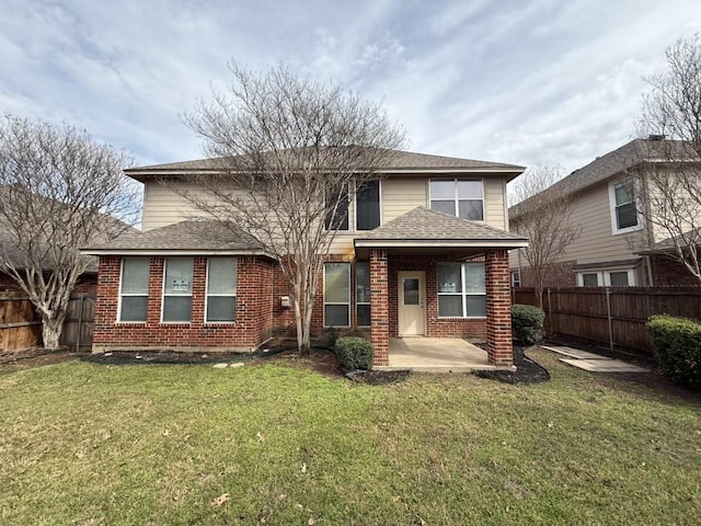 rear view of house featuring a yard, brick siding, a fenced backyard, and a patio area