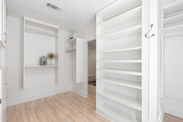 spacious closet with visible vents and wood finished floors