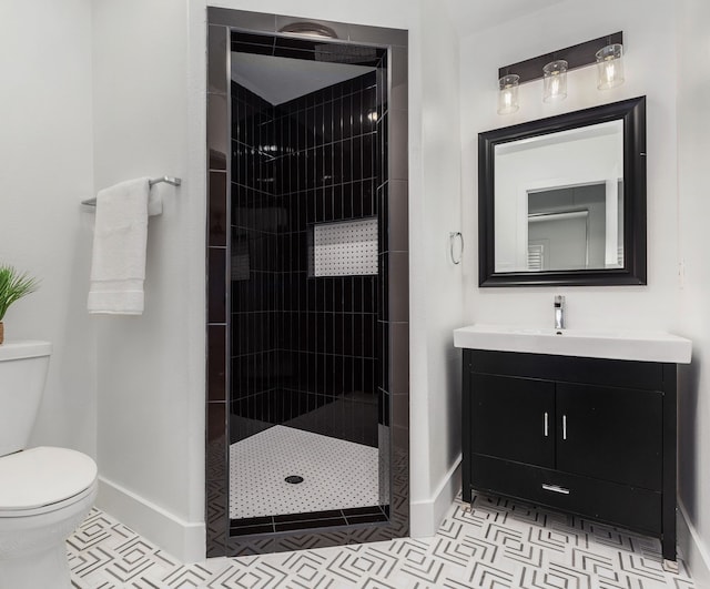 full bath featuring vanity, baseboards, a tile shower, tile patterned floors, and toilet