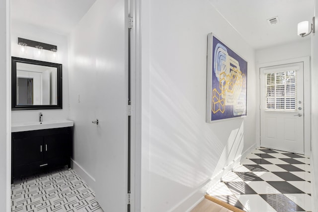 bathroom with tile patterned floors, visible vents, baseboards, and vanity