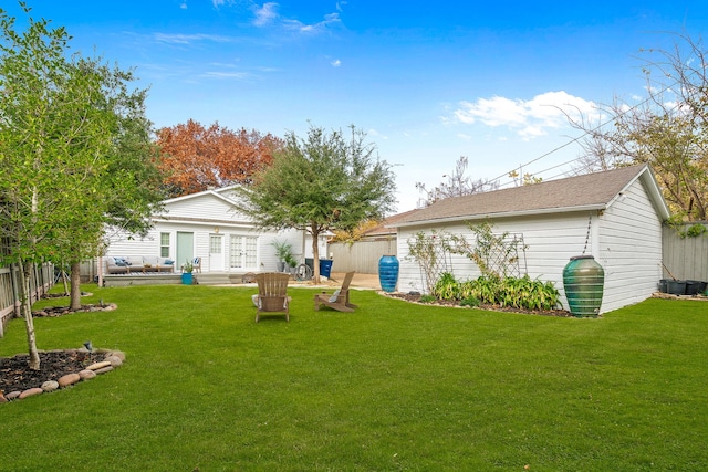 view of yard with an outdoor structure and fence