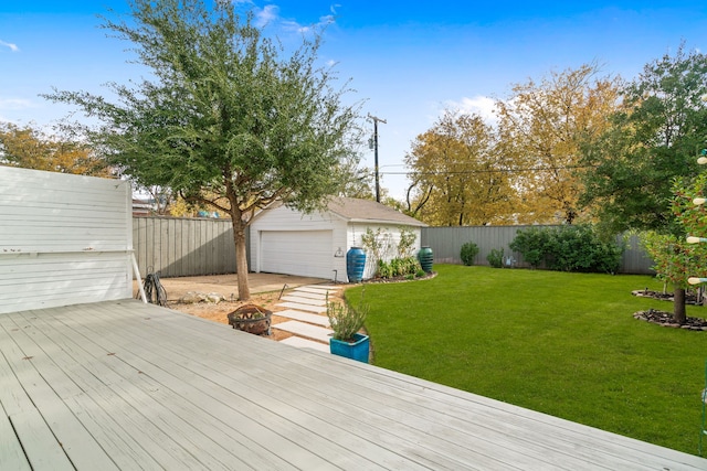 wooden terrace featuring a yard, a garage, a fenced backyard, and an outdoor structure