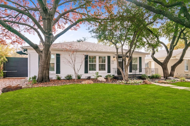 single story home with a front lawn and brick siding