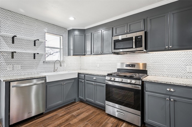 kitchen with open shelves, dark wood-style flooring, a sink, gray cabinetry, and stainless steel appliances