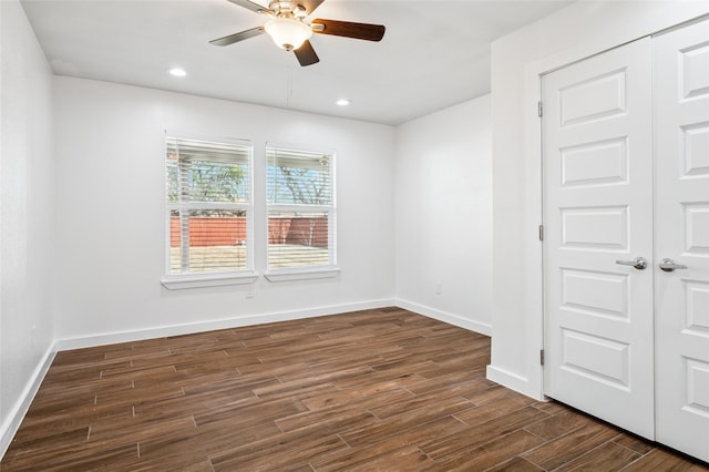 empty room with recessed lighting, dark wood-style floors, and baseboards