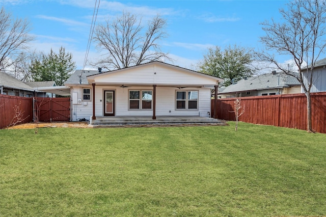 back of property featuring a fenced backyard, a patio area, a yard, and a ceiling fan