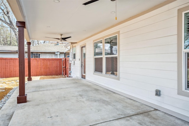 view of patio with a ceiling fan and fence