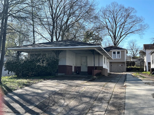 view of home's exterior with brick siding, an attached garage, and concrete driveway