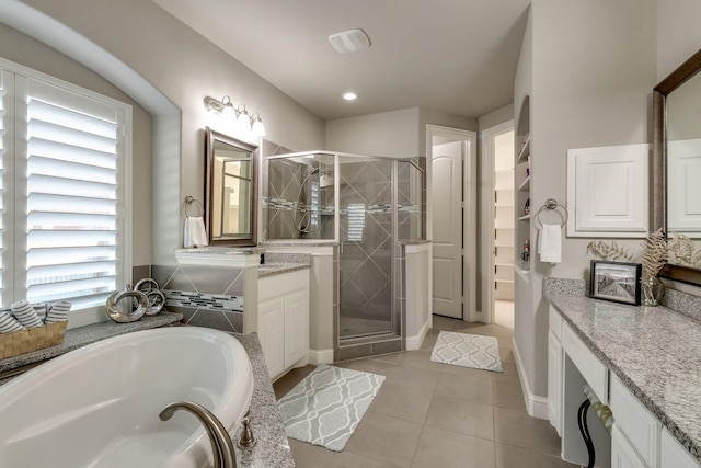 full bath with vanity, a garden tub, a stall shower, and tile patterned floors