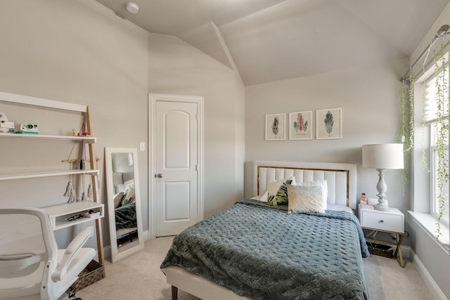 bedroom with multiple windows, lofted ceiling, carpet, and baseboards