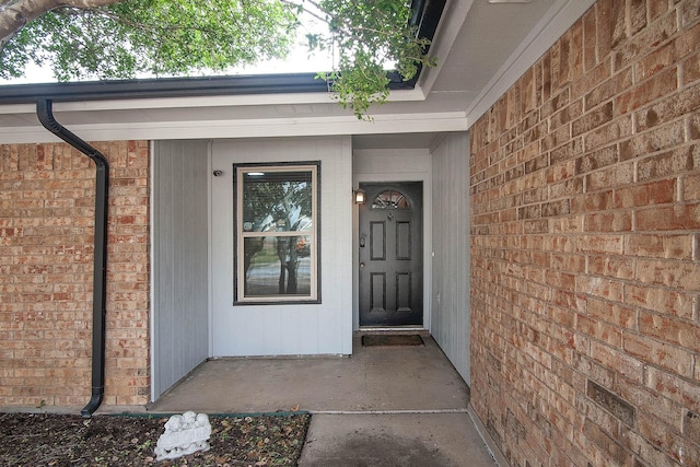 property entrance featuring brick siding