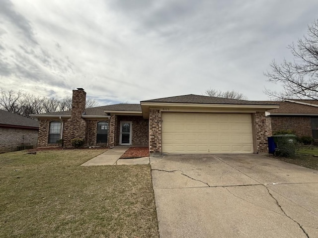 view of front of property with a front lawn, concrete driveway, a garage, brick siding, and a chimney