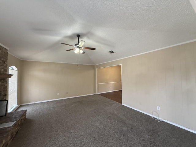 unfurnished living room with a ceiling fan, visible vents, a fireplace, a textured ceiling, and crown molding