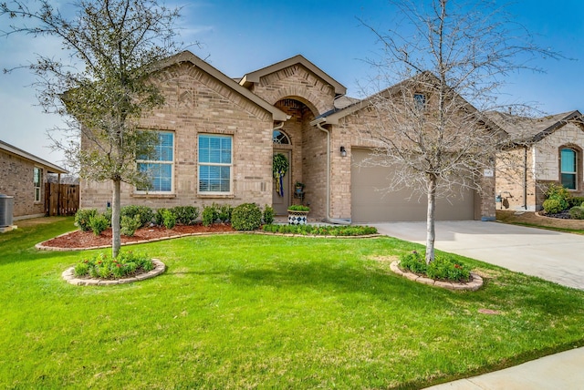 view of front of property with brick siding, driveway, and a front yard