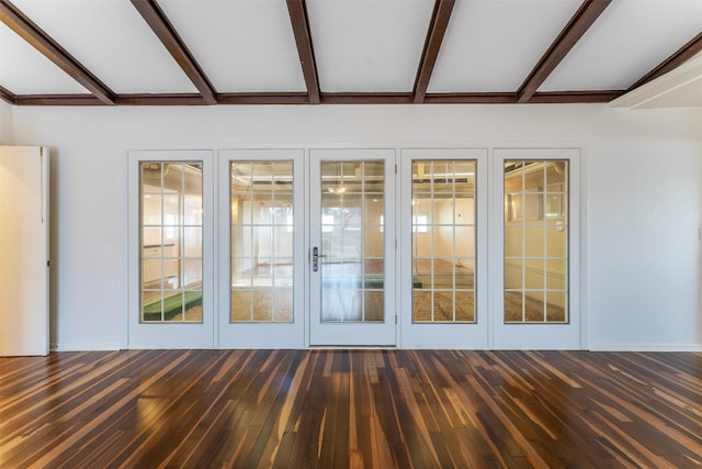 interior space with dark wood finished floors and lofted ceiling with beams