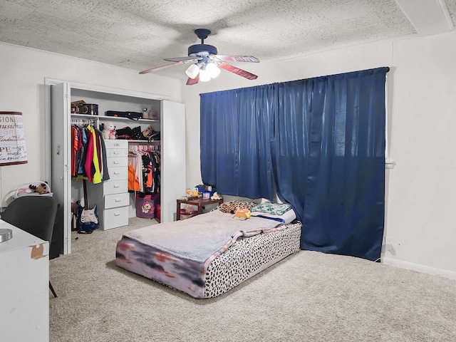 bedroom featuring a closet, baseboards, a ceiling fan, and carpet flooring