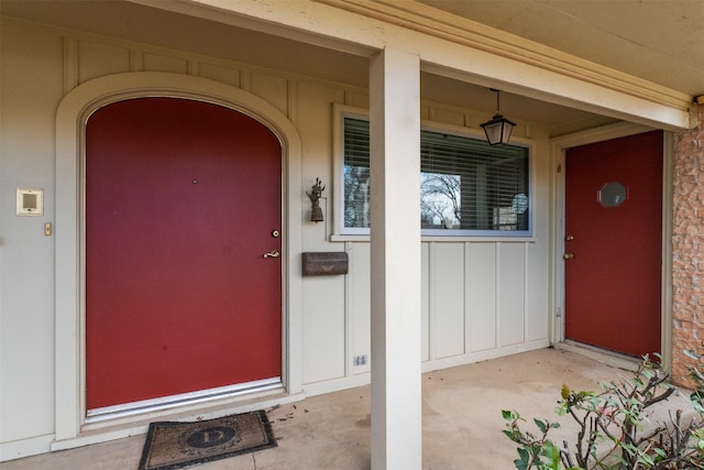 doorway to property with a porch and board and batten siding