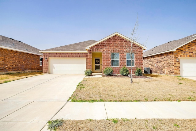 ranch-style house featuring brick siding, an attached garage, driveway, and central AC