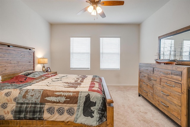 bedroom with baseboards, light colored carpet, and a ceiling fan