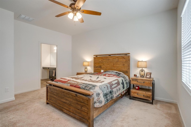 bedroom with visible vents, light carpet, and baseboards