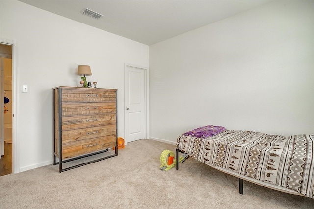 carpeted bedroom featuring baseboards and visible vents