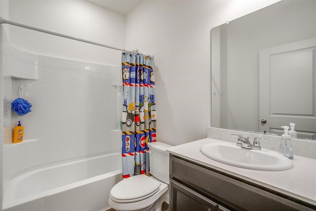 bathroom featuring shower / tub combo, toilet, and vanity