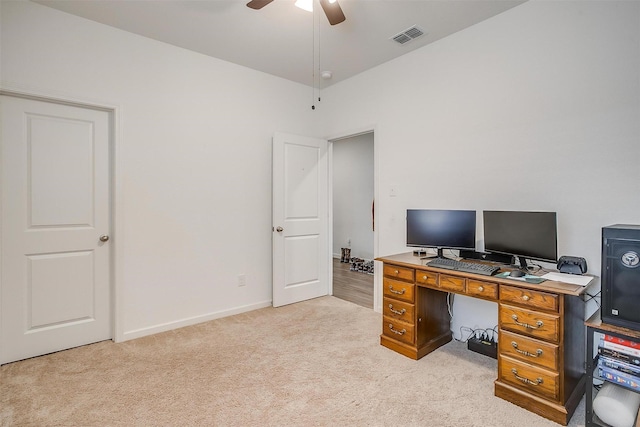 office with a ceiling fan, light colored carpet, visible vents, and baseboards