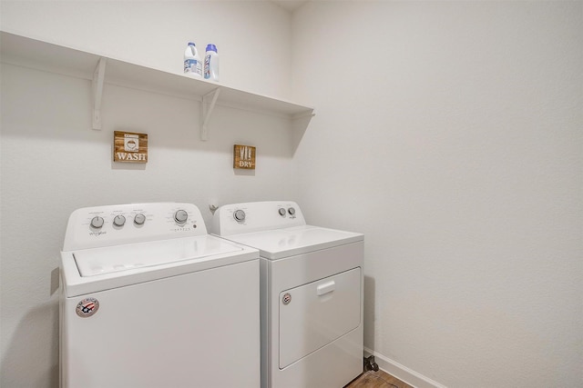 laundry room featuring baseboards, laundry area, and washer and clothes dryer