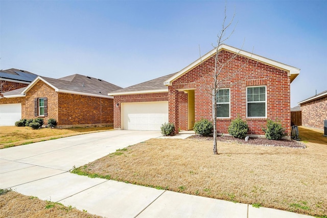 ranch-style home with a front yard, driveway, roof with shingles, a garage, and brick siding