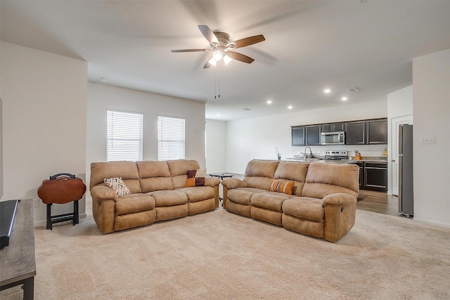 living room featuring recessed lighting, visible vents, light colored carpet, and ceiling fan