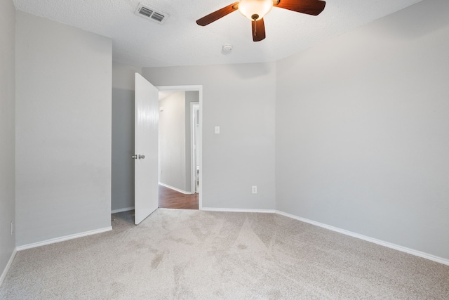 unfurnished bedroom with visible vents, carpet flooring, a textured ceiling, and baseboards