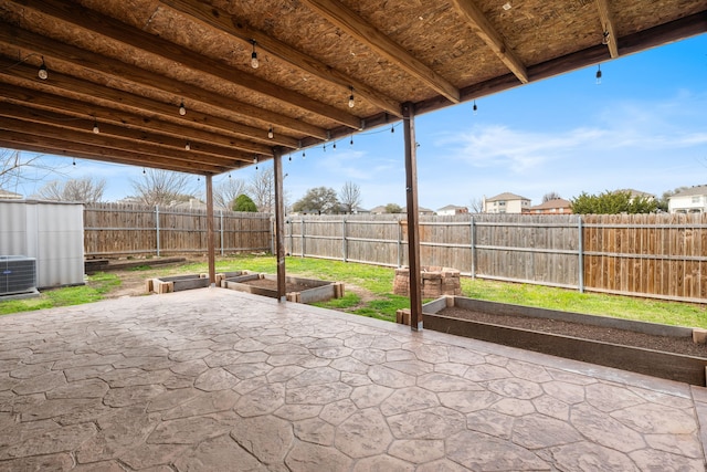 view of patio featuring a garden, central air condition unit, and a fenced backyard