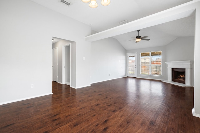 unfurnished living room with ceiling fan, visible vents, a fireplace with raised hearth, and dark wood finished floors