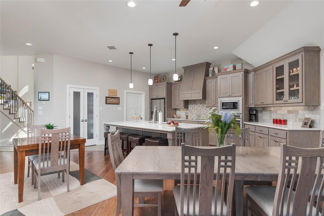 dining area featuring visible vents, dark wood-type flooring, stairs, recessed lighting, and french doors