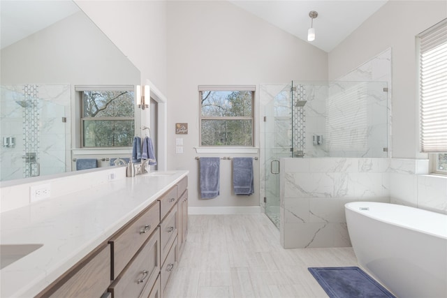 bathroom with a marble finish shower, a soaking tub, double vanity, a sink, and vaulted ceiling